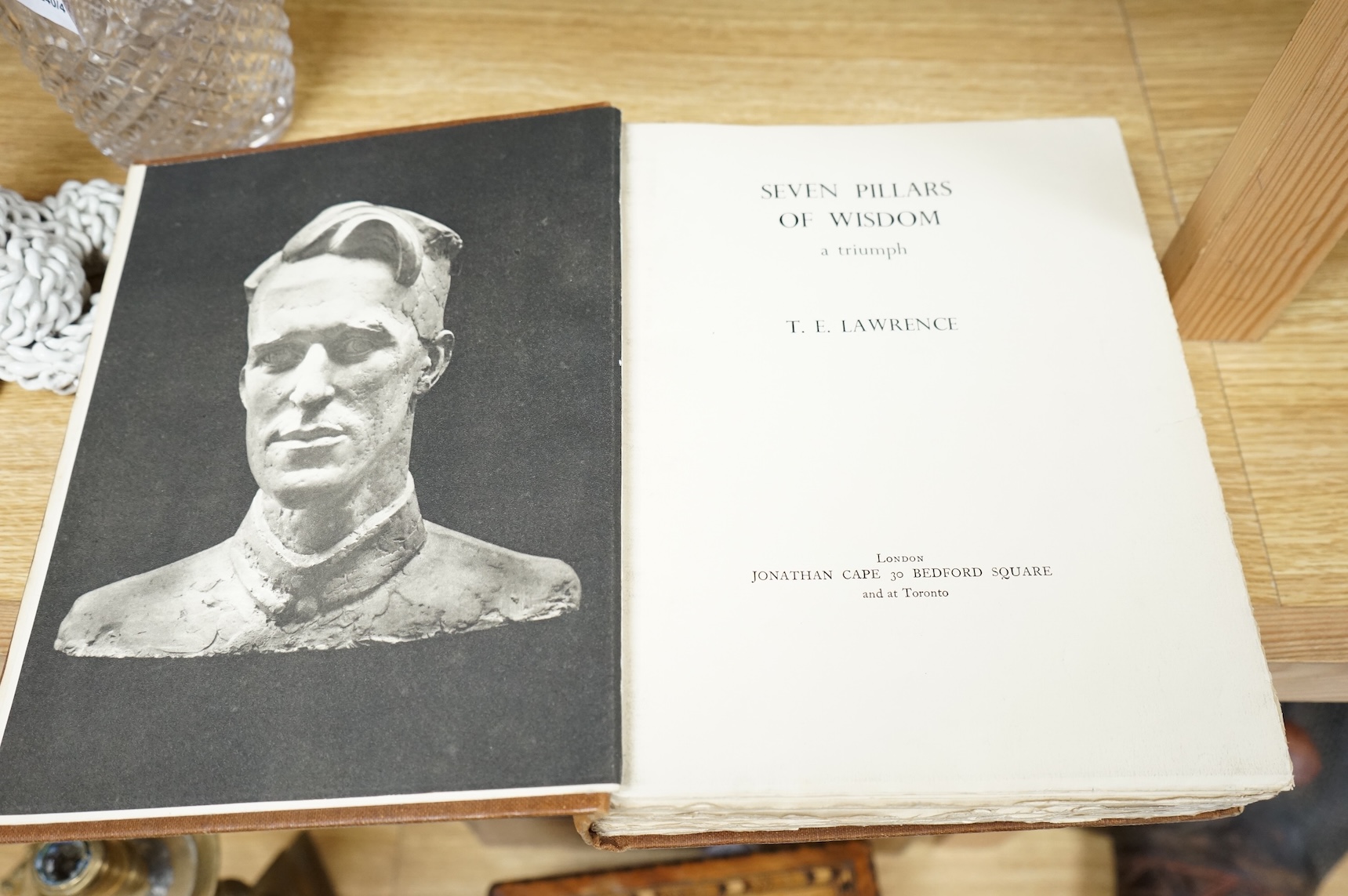 Lawrence, T.E. - Seven Pillars of Wisdom: a triumph. First Trade Edition. portrait frontis., num. portrait plates, 4 folded maps (outline colour) and some text illus.; original gilt cloth, roy. 8vo. 1935.